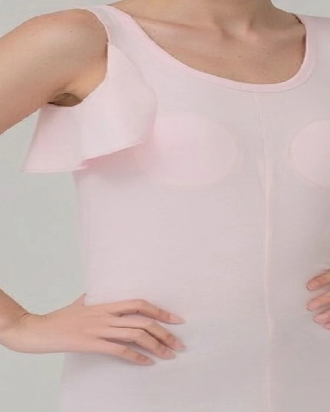 Close-up of the axilla flap panel and scoop neckline on a SpineShield knit liner